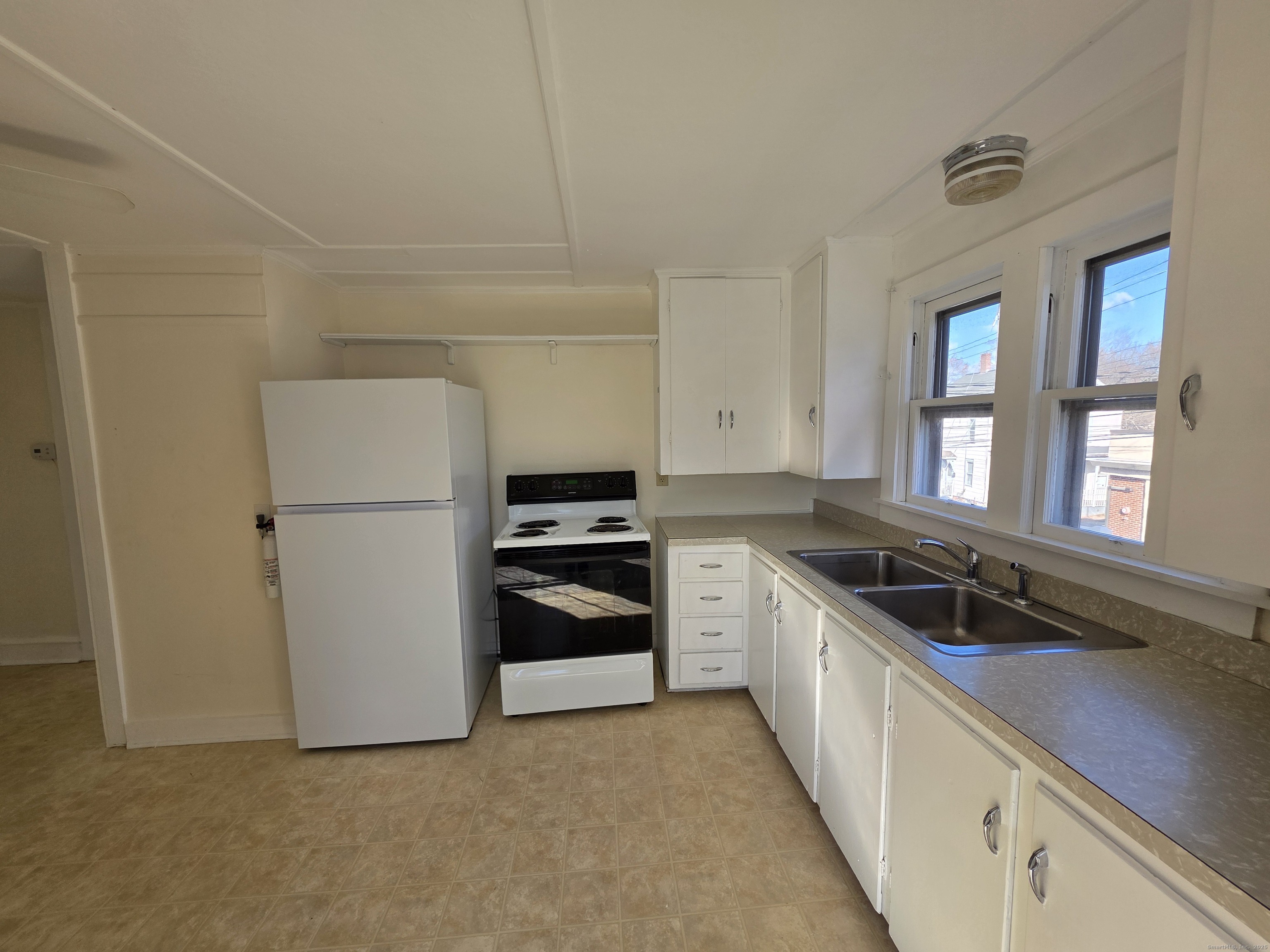 110 Main Street Griswold, CT 06351 - Photo 21 of 32 a kitchen with a refrigerator and a sink