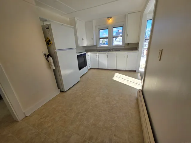 a view of a hallway to a room with window
