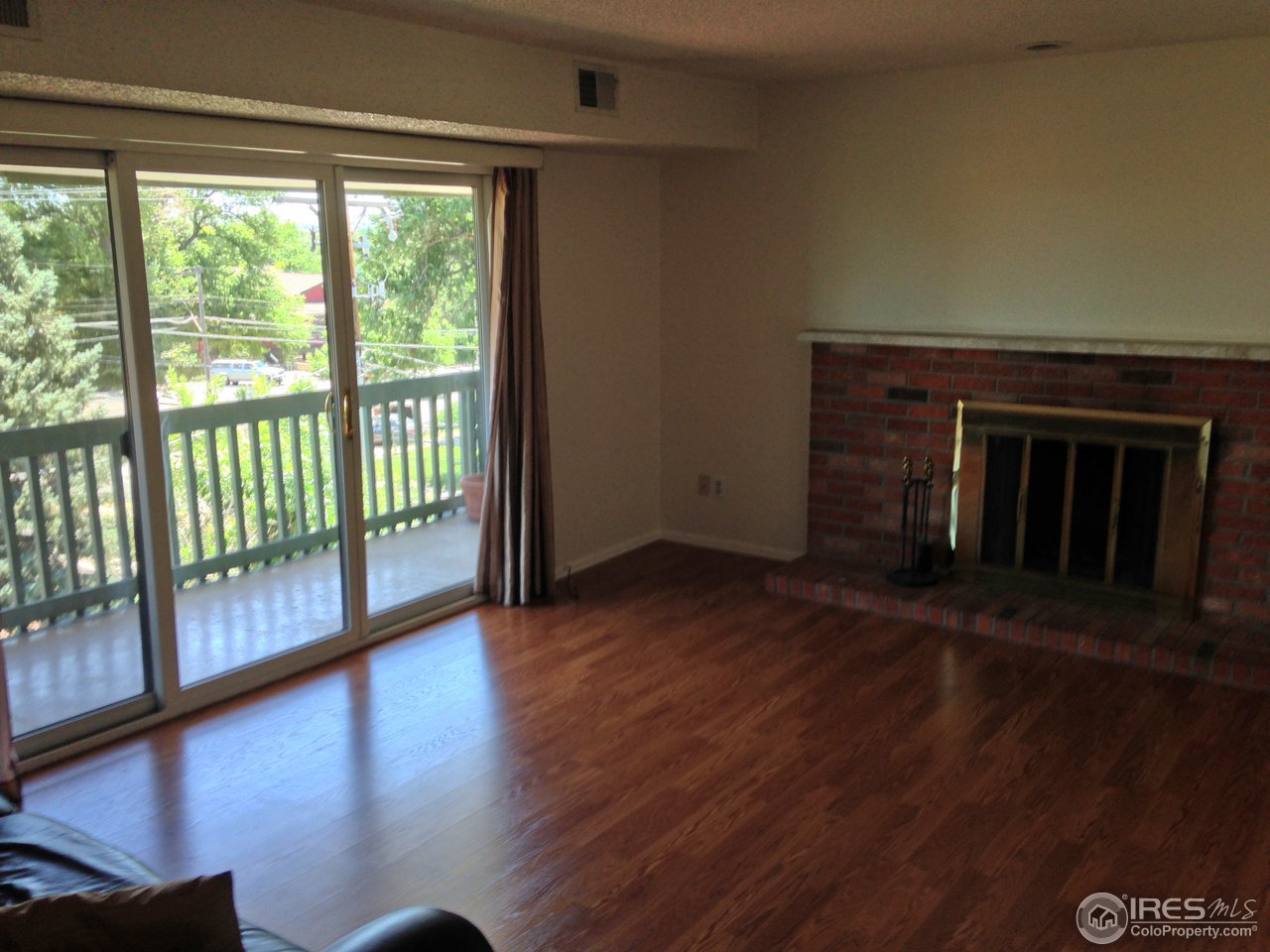 2141 Baseline Road, Unit 23 Boulder, CO 80302 - Photo 3 of 13 a view of a room with wooden floor and a floor to ceiling window
