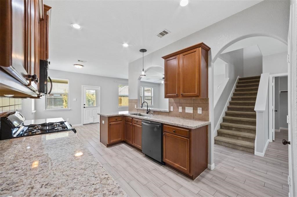 22438 Toronado Ridge Lane Porter, TX 77365 - Photo 5 of 19 Spacious kitchen featuring a sleek stainless steel refrigerator, perfect for culinary enthusiasts.