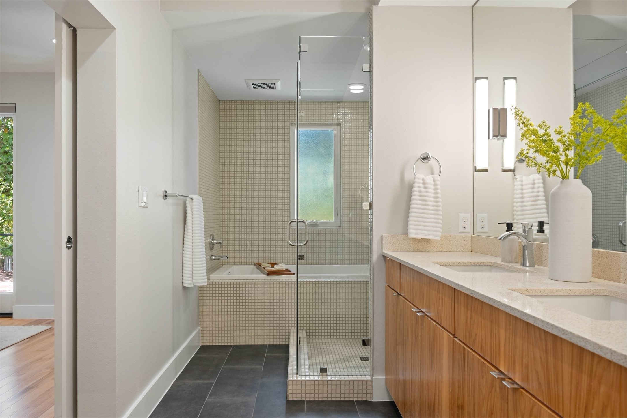 3921 Threadgill Street Austin, TX 78723 - Photo 6 of 36 Contemporary tile work and polished modern fixtures turn your daily routine into a calm, refreshing experience in the primary ensuite bath