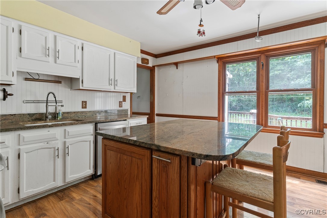 3125 Nahant Road Midlothian, VA 23112 - Photo 9 of 36 a kitchen with stainless steel appliances granite countertop a stove a sink dishwasher and cabinets with wooden floor