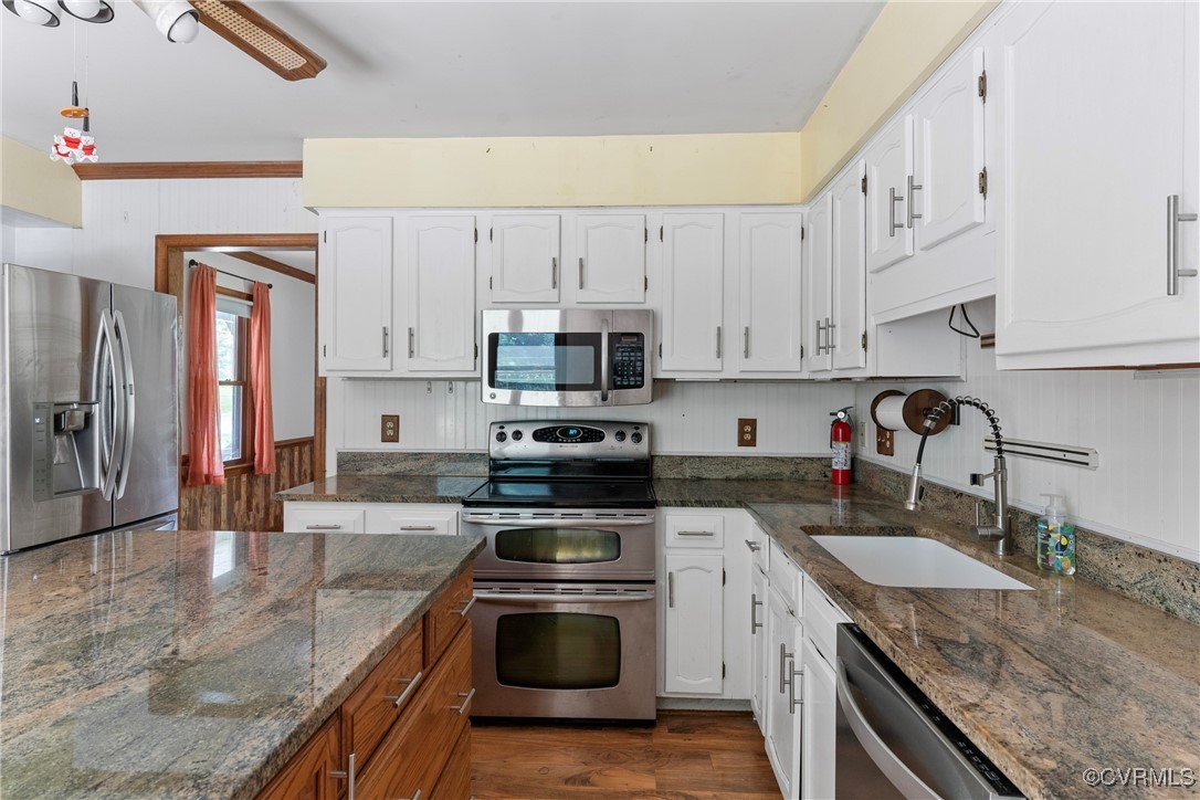 3125 Nahant Road Midlothian, VA 23112 - Photo 10 of 36 a kitchen with granite countertop a sink a stove and cabinets