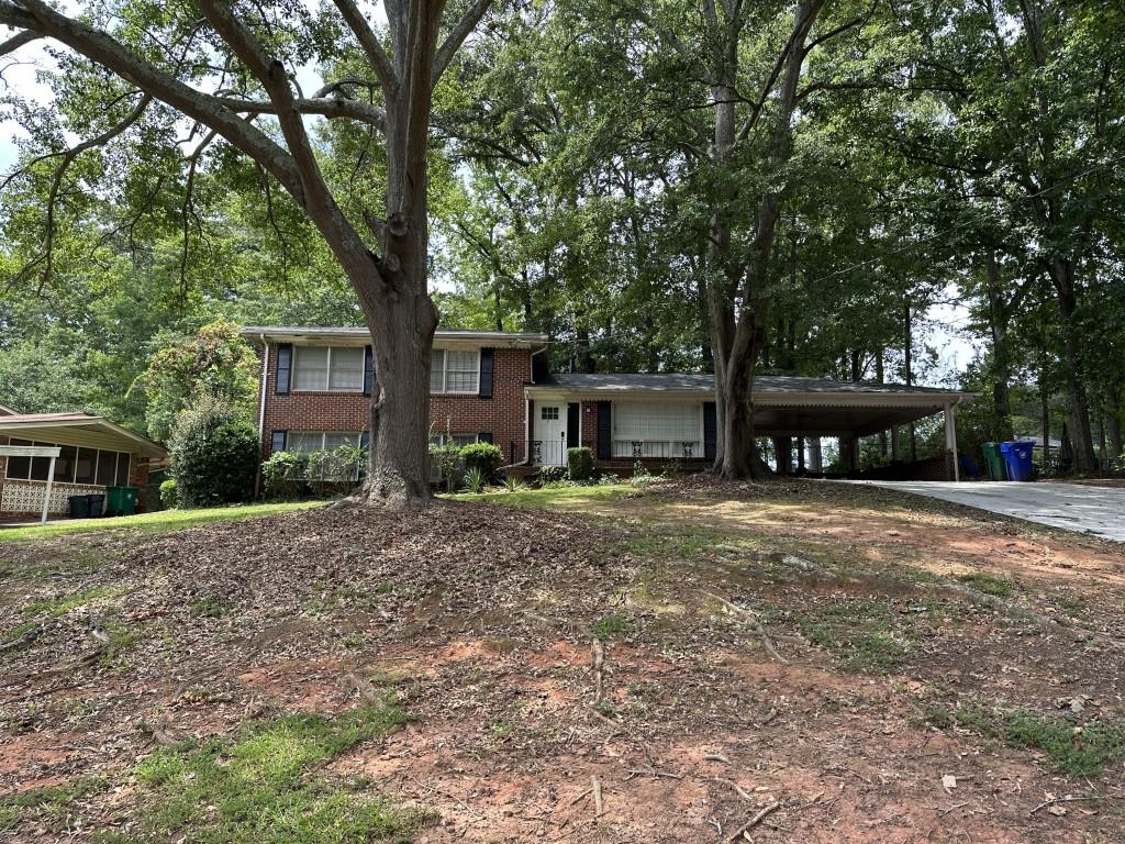 3210 Thrasher Circle Decatur, GA 30032 - Photo 1 of 1 a front view of a house with a yard and large trees
