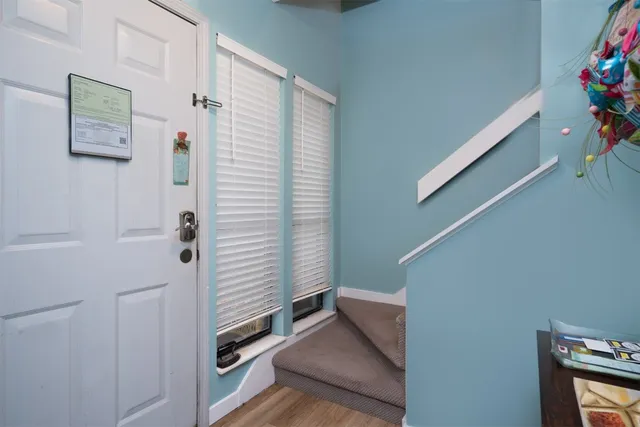 a view of an entryway with wooden floor