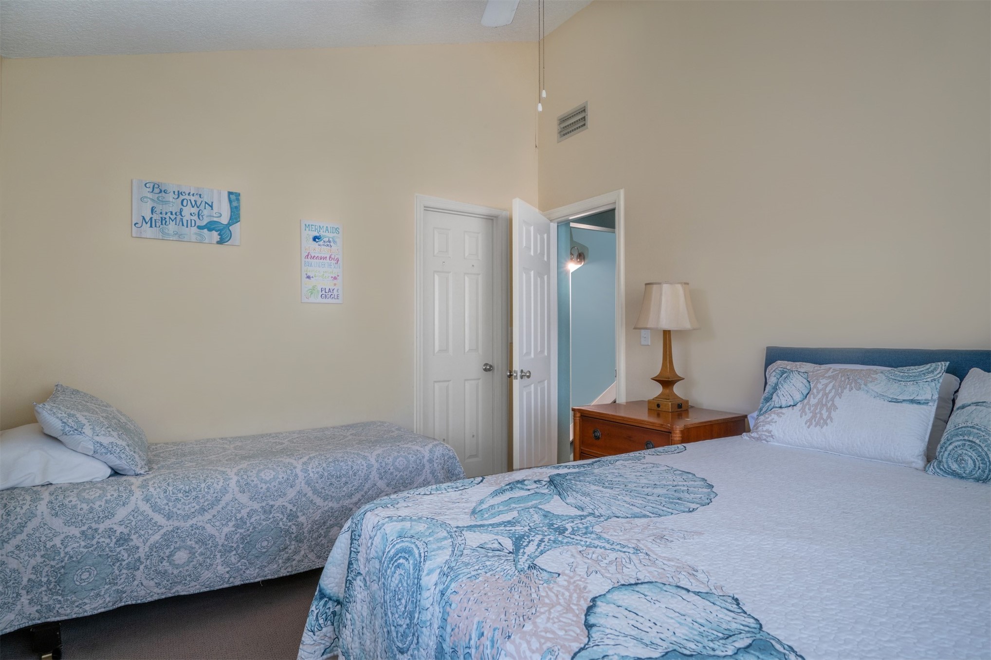 2892 Forest Ridge Drive, Unit V2 Fernandina Beach, FL 32034 - Photo 17 of 32 a bedroom with two beds and a lamp