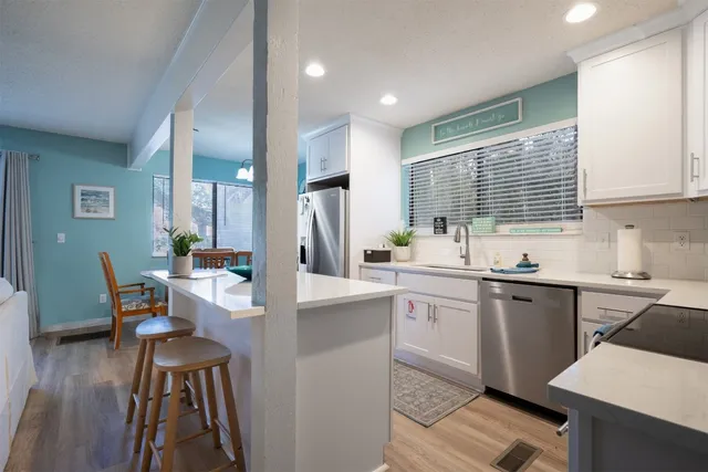 a kitchen with sink cabinets and wooden floor