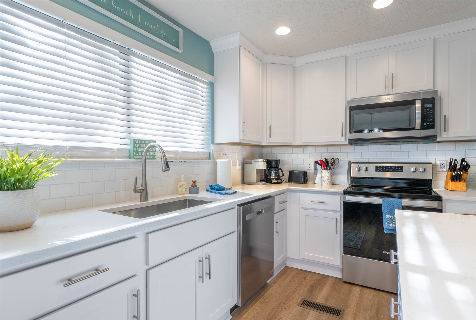 2892 Forest Ridge Drive, Unit V2 Fernandina Beach, FL 32034 - Photo 8 of 32 a kitchen with sink a microwave and cabinets
