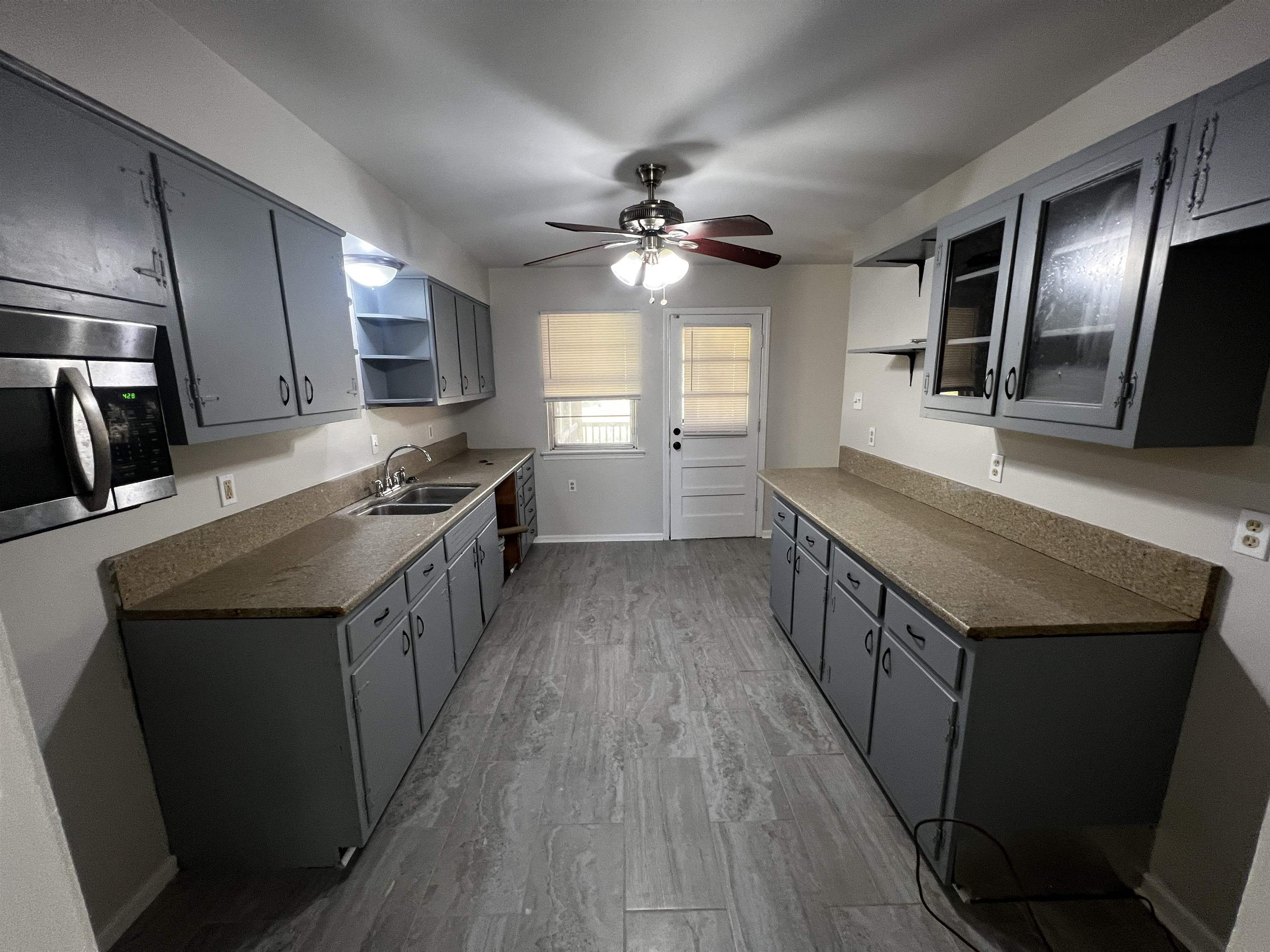5388 Virgil Road Bartlett, TN 38134 - Photo 2 of 13 Kitchen with open shelves, stainless steel microwave, a sink, dark countertops, and ceiling fan