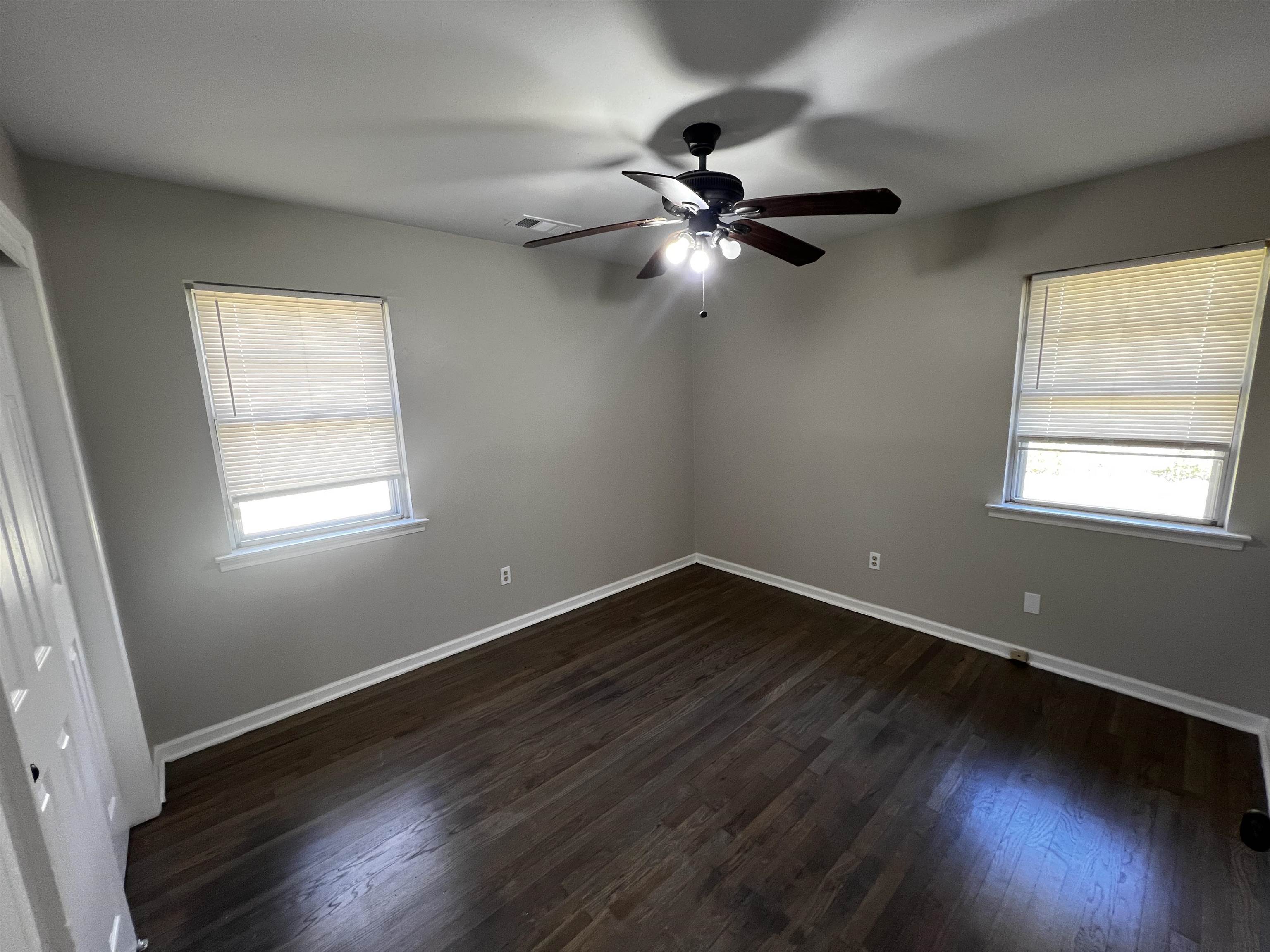 5388 Virgil Road Bartlett, TN 38134 - Photo 6 of 13 Spare room featuring a ceiling fan, visible vents, baseboards, and dark wood finished floors
