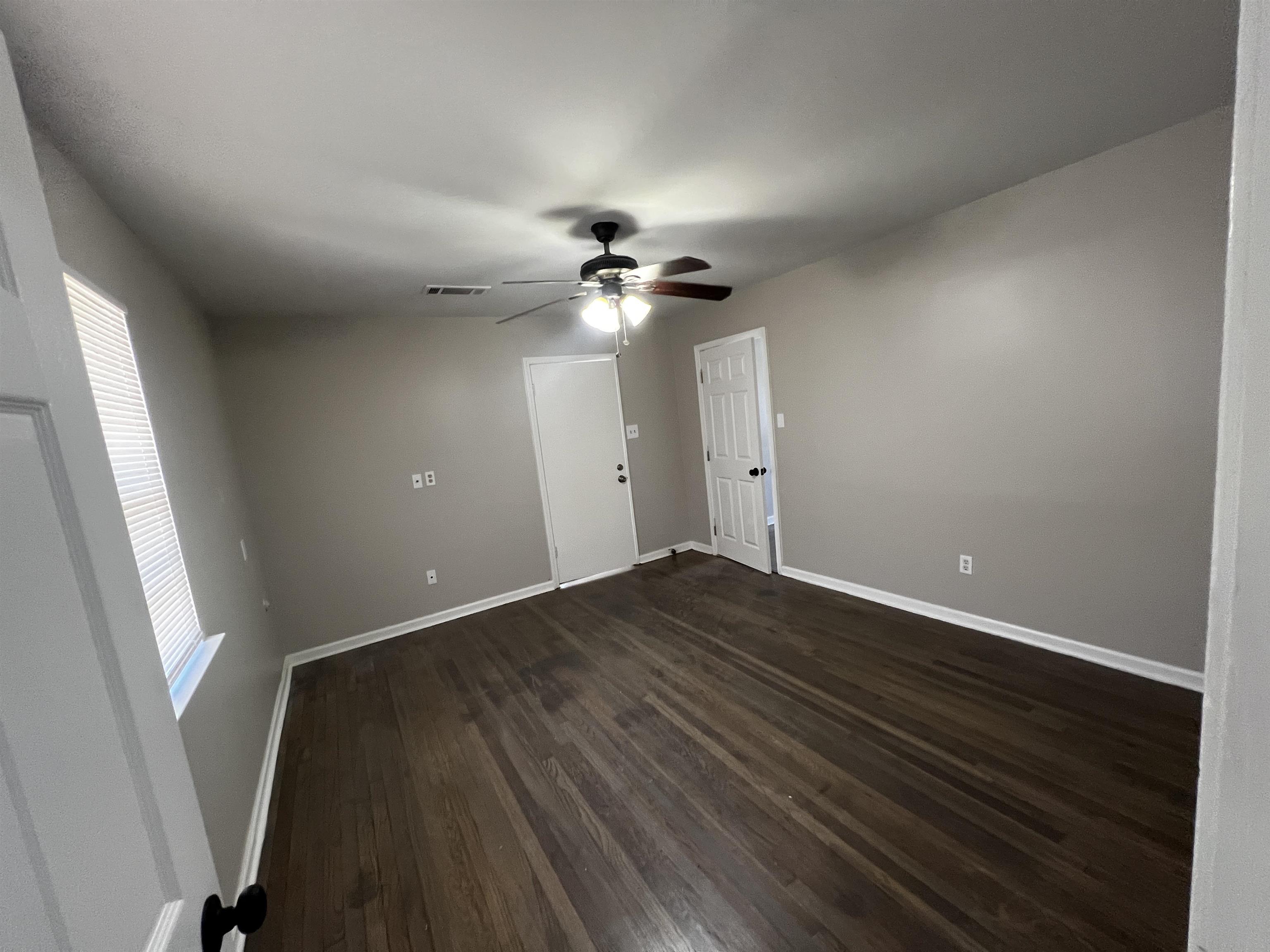 5388 Virgil Road Bartlett, TN 38134 - Photo 7 of 13 Spare room with dark wood finished floors, baseboards, visible vents, and ceiling fan