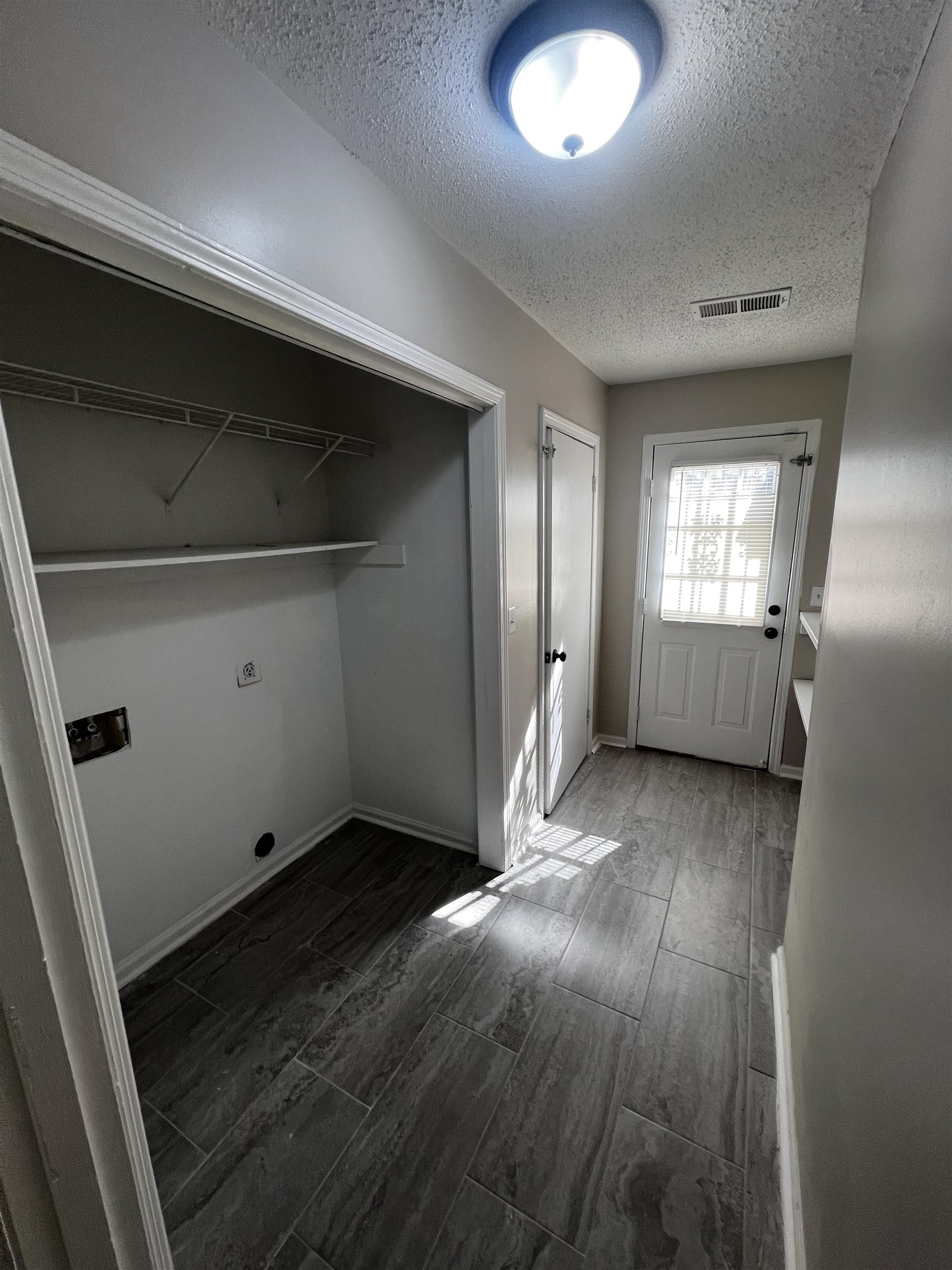 5388 Virgil Road Bartlett, TN 38134 - Photo 8 of 13 Clothes washing area with electric dryer hookup, laundry area, wood finish floors, visible vents, and hookup for a washing machine