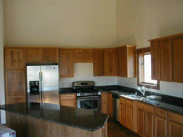 357 Faas Ranch Road New Castle, CO 81647 - Photo 2 of 4 a kitchen with granite countertop a refrigerator and a sink