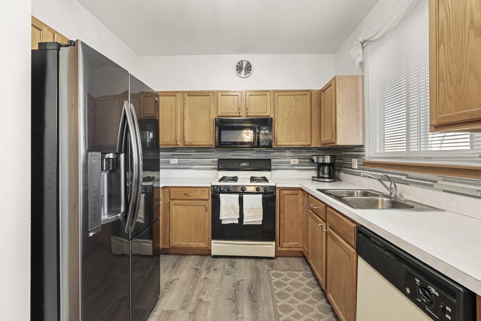 21628 Dogwood Road, Unit 1203 Matteson, IL 60443 - Photo 11 of 20 a kitchen with stainless steel appliances a stove a sink and a refrigerator