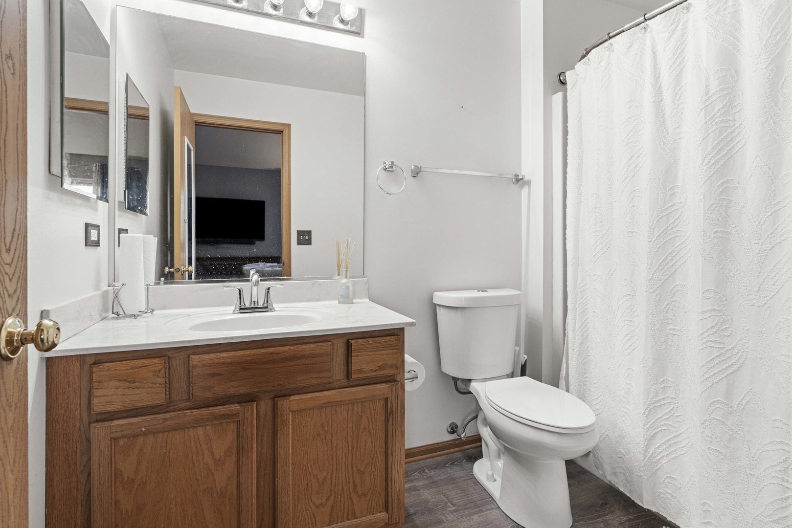21628 Dogwood Road, Unit 1203 Matteson, IL 60443 - Photo 14 of 20 a bathroom with a toilet a sink and a mirror