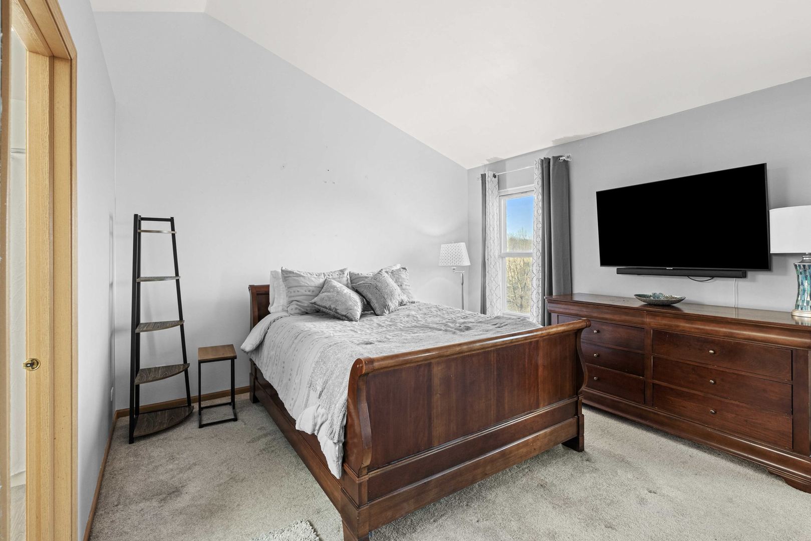 21628 Dogwood Road, Unit 1203 Matteson, IL 60443 - Photo 18 of 20 a bedroom with a bed and a flat screen tv