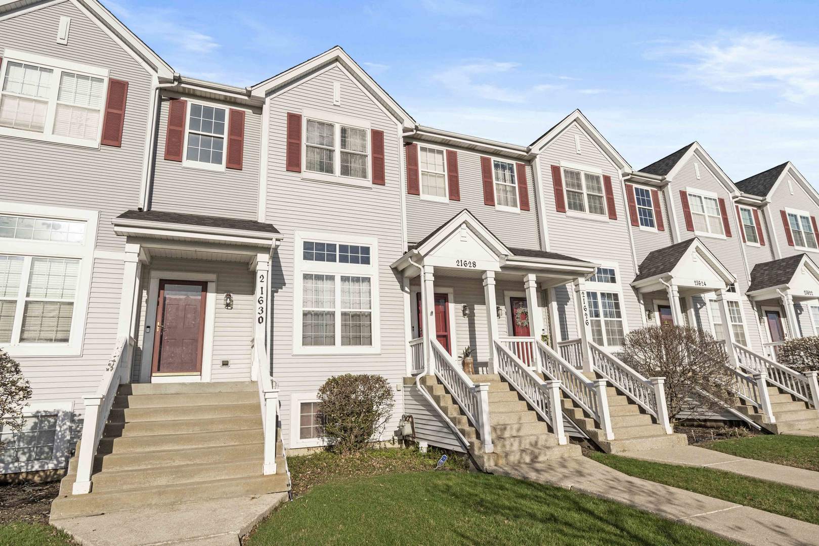 21628 Dogwood Road, Unit 1203 Matteson, IL 60443 - Photo 2 of 20 a front view of a house with a yard