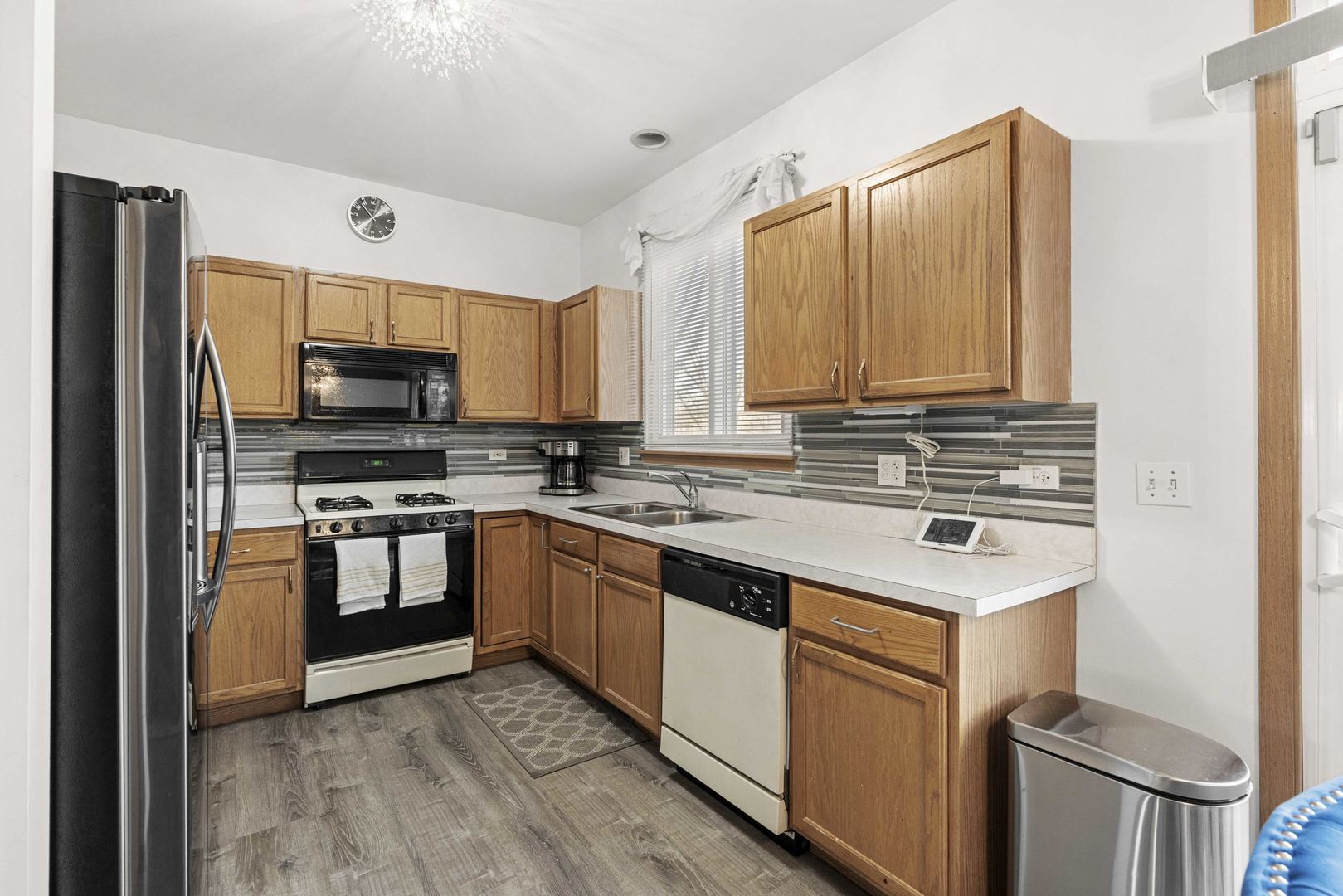 21628 Dogwood Road, Unit 1203 Matteson, IL 60443 - Photo 9 of 20 a kitchen with stainless steel appliances a sink a stove a microwave a sink a refrigerator and cabinets