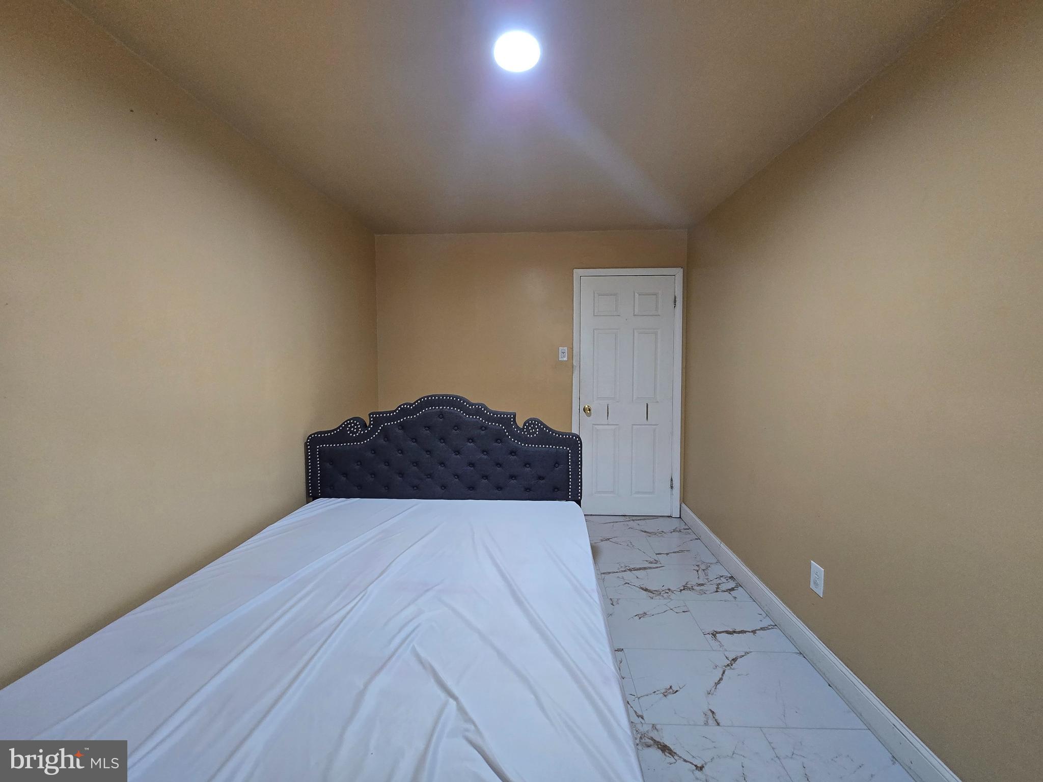 2118 Benson Street Philadelphia, PA 19152 - Photo 16 of 26 a view of a room has a bed and a lamp on desk