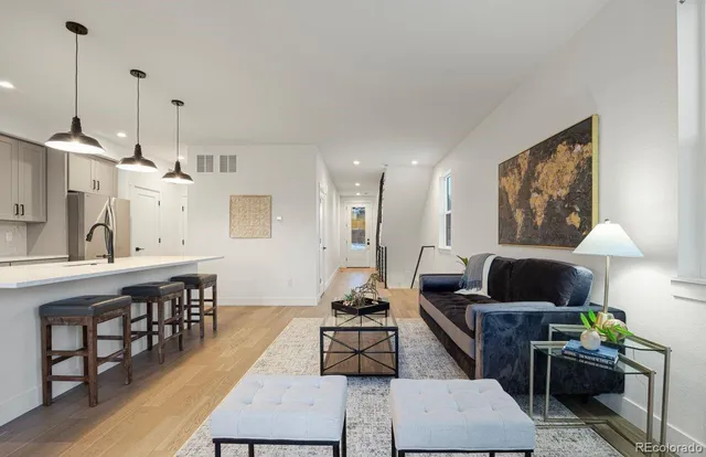 a living room with furniture a window and a chandelier