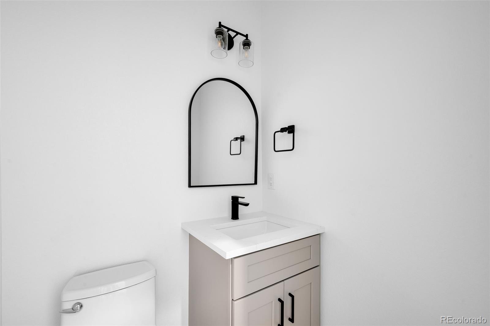 4660 West 9th Avenue Denver, CO 80204 - Photo 12 of 35 a bathroom with a sink and a mirror