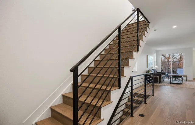 a view of entryway and hall with wooden floor
