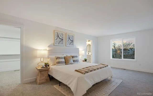 a bedroom with a large bed and a window