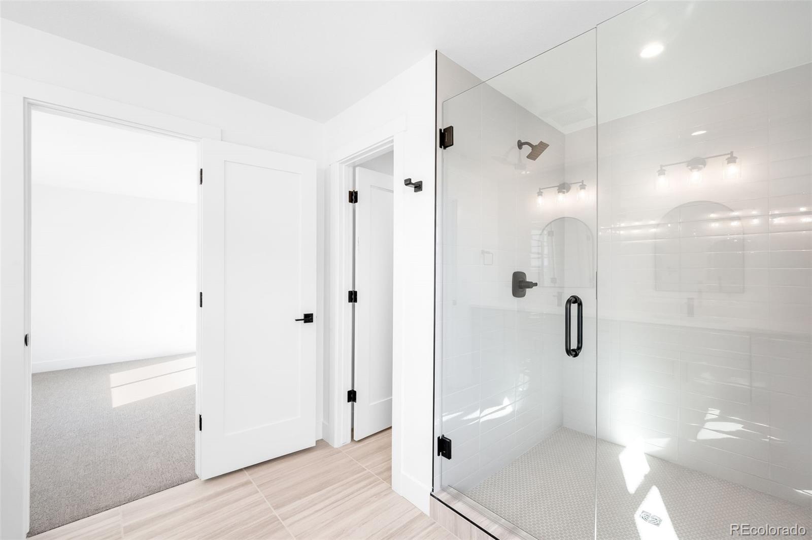 4660 West 9th Avenue Denver, CO 80204 - Photo 16 of 35 a bathroom with a shower and a glass door