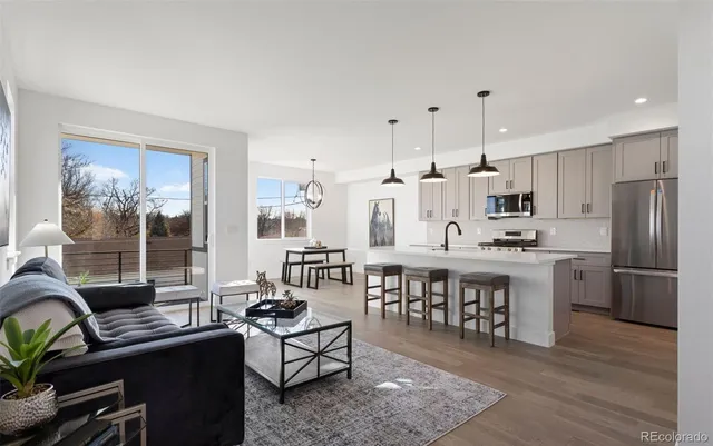 a kitchen with stainless steel appliances kitchen island granite countertop a sink and cabinets