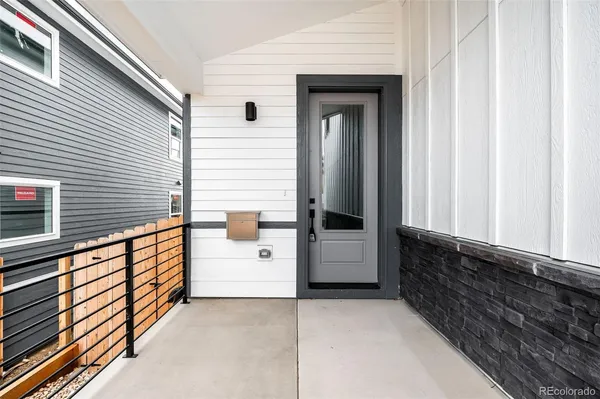 a large white kitchen with kitchen island a sink a stove a refrigerator and white cabinets