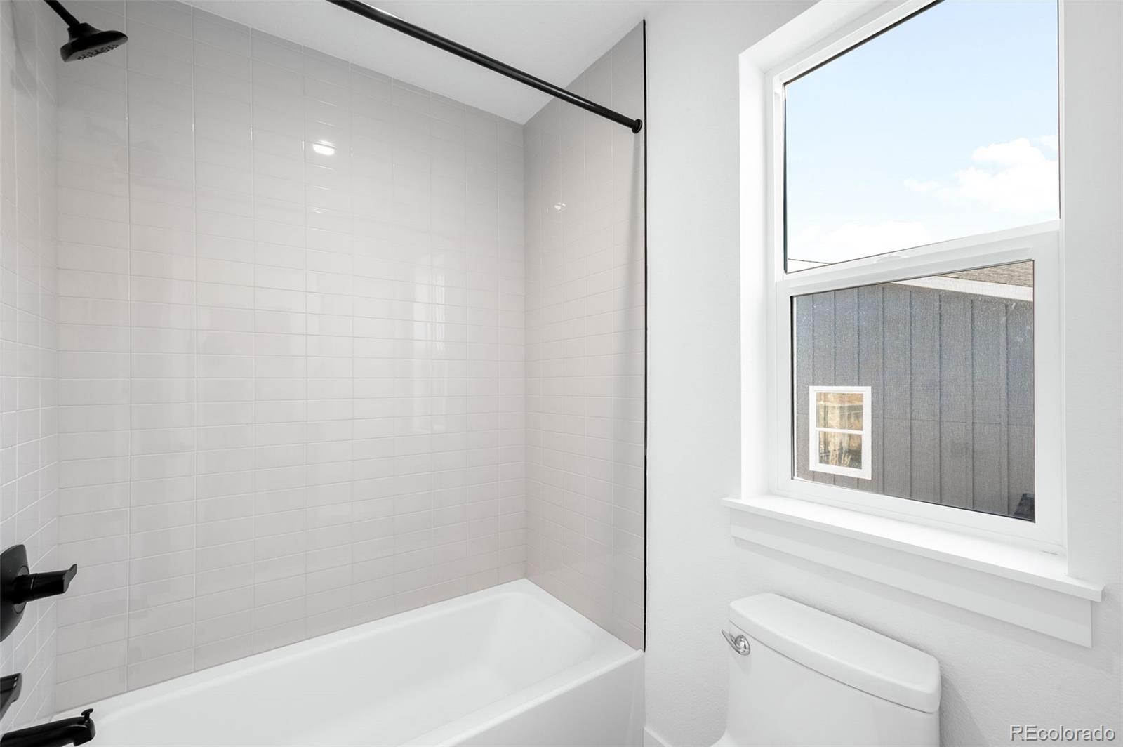 4660 West 9th Avenue Denver, CO 80204 - Photo 21 of 35 a bathroom with a shower and a toilet