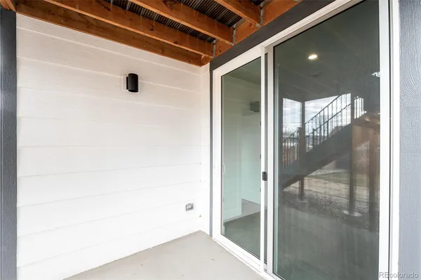 a view of a house with large windows and a big yard