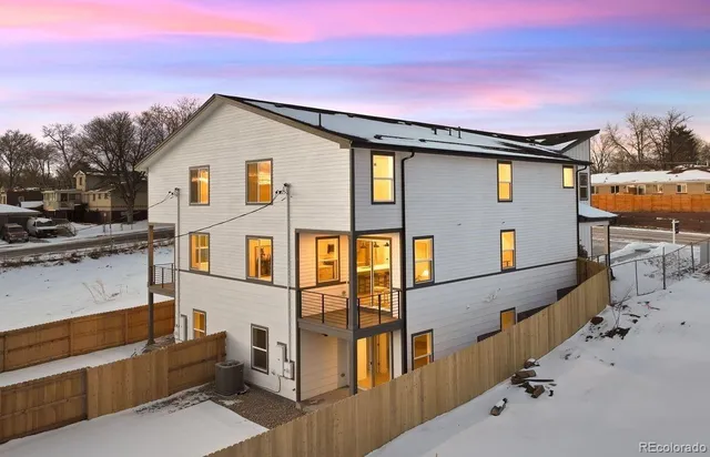 a view of a house with wooden fence