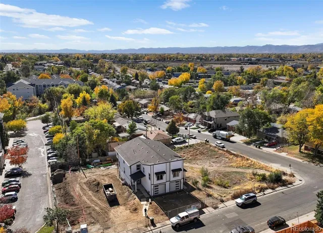 an aerial view of residential houses with outdoor space