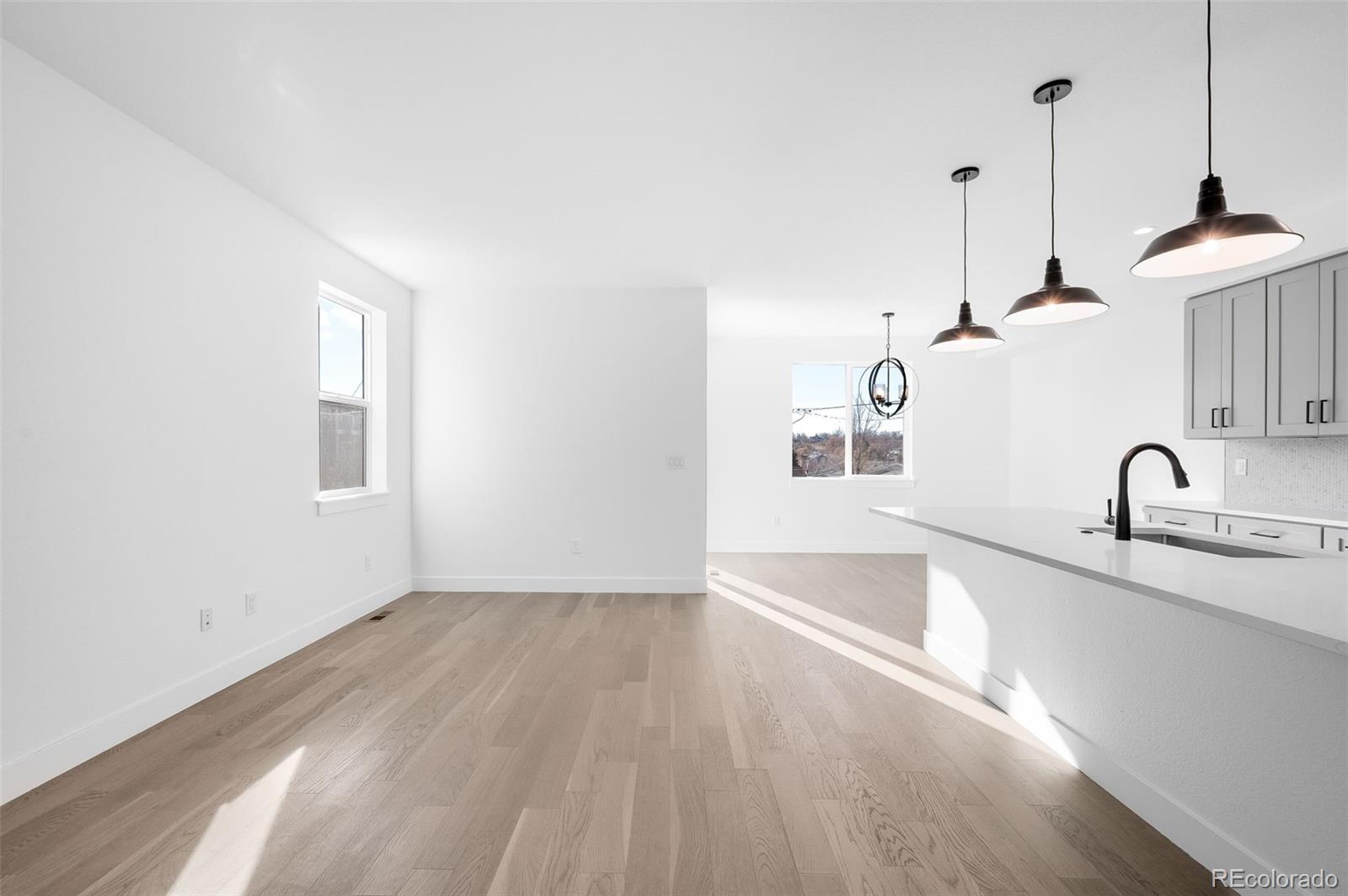 4660 West 9th Avenue Denver, CO 80204 - Photo 6 of 35 a view of a kitchen with a sink cabinets and a wooden floor