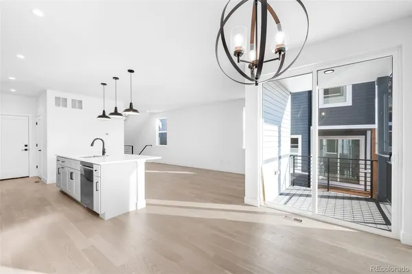 a view of a balcony with wooden floor and cabinet