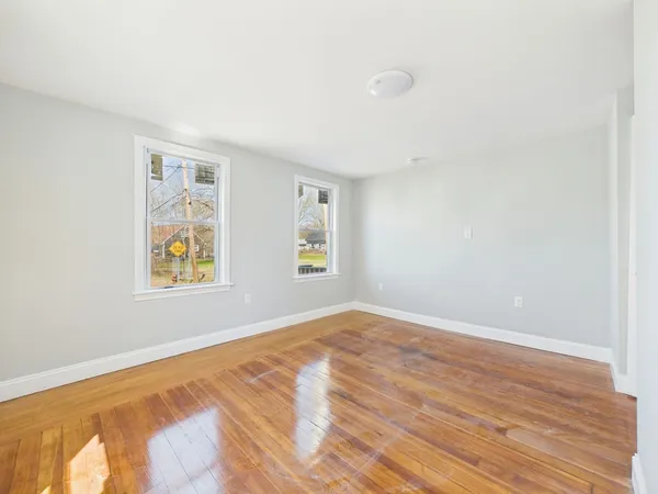 a view of room with window and wooden floor