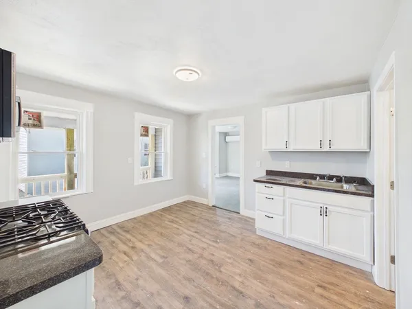 a kitchen with granite countertop a stove and a sink