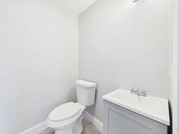 a white toilet sitting next to a white sink