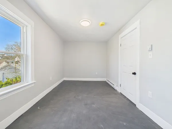 a view of an empty room with a window