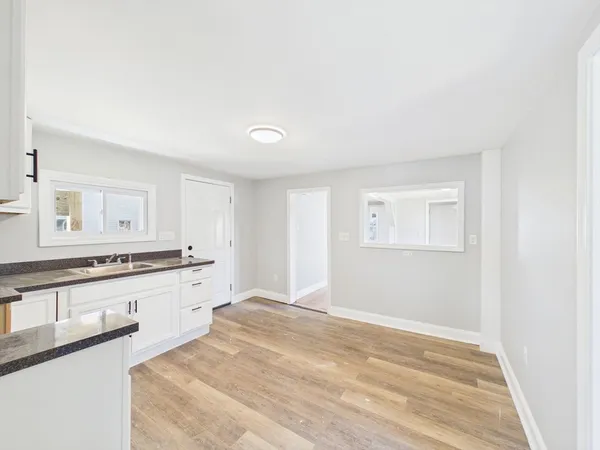 a spacious bathroom with a granite countertop sink and a mirror