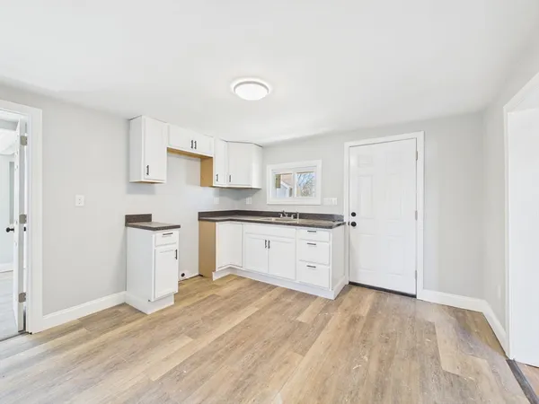 a view of kitchen with wooden floor