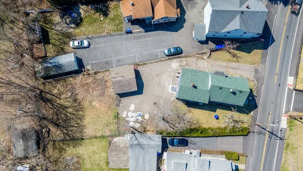 an aerial view of a house with a yard basket ball court and outdoor seating