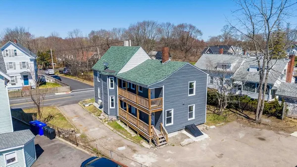 a aerial view of a house with a yard table and chairs
