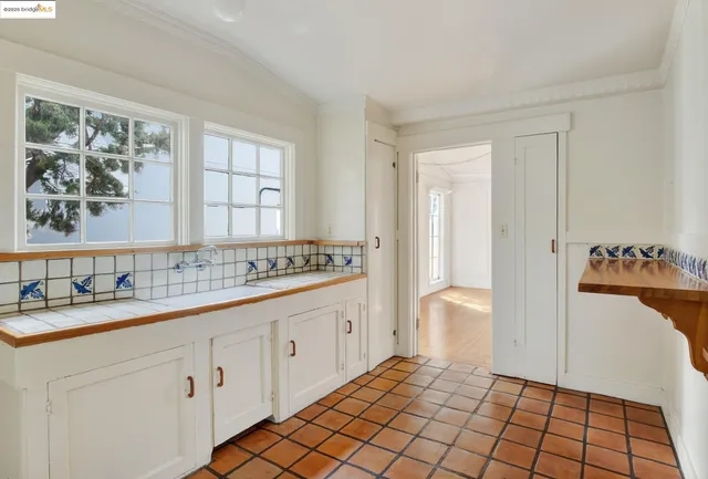 a kitchen with a sink appliances and cabinets