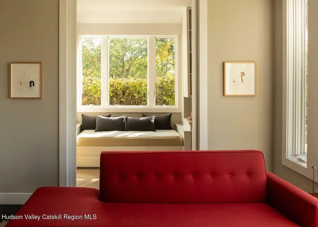 a bedroom with a bed and a large window