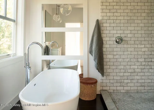 a bedroom with a bed and glass window