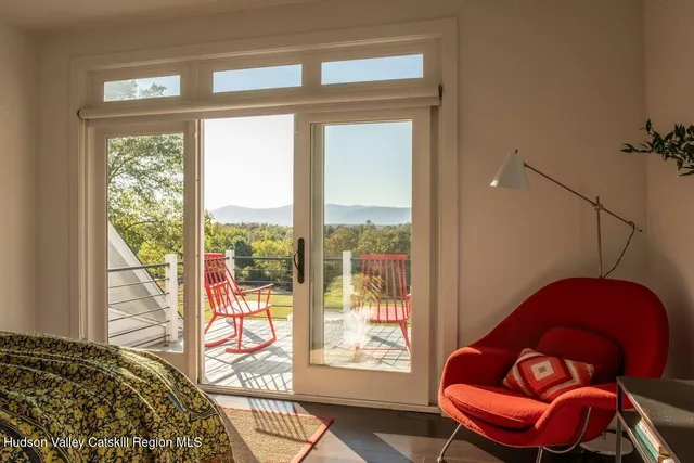 a view of a room that has a bed and wooden floor