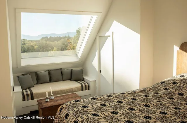 a bedroom with a bed and a window