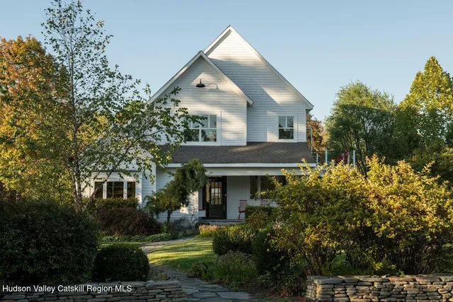 a front view of a house with swimming pool and a yard